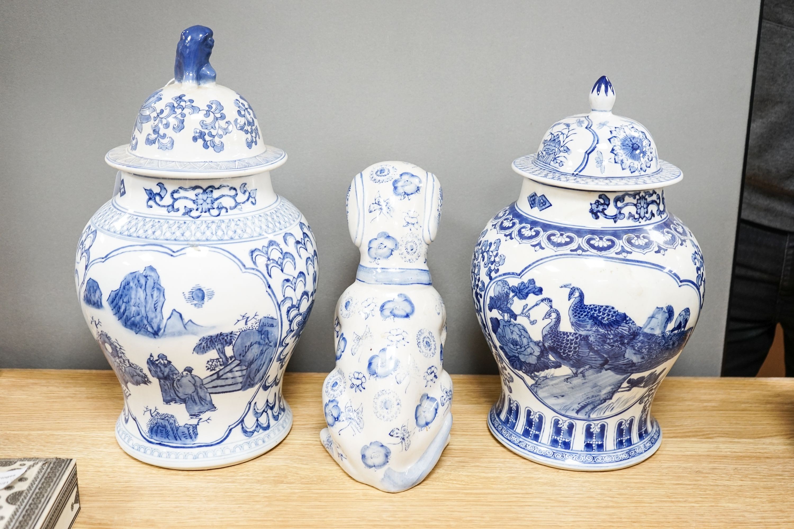 2 modern Chinese blue and white vases and covers and a similar model of a dog.